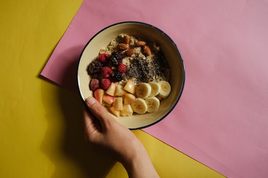 a colorful bowl of oatmeal topped with fruits and nuts